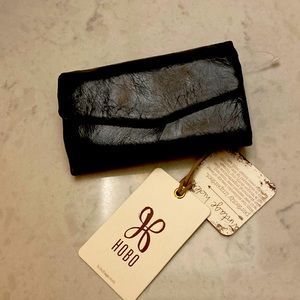 Black wallet by Hobo. New With Tags. Spacious interior w/ many slots.